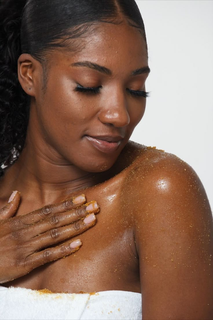 Woman applying sugar body scrub on skin for smooth glowing results
