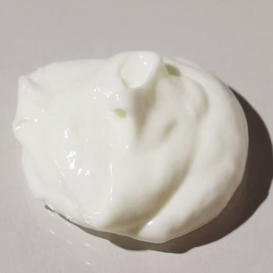 Close-up of creamy, thick, moisturizing leave-in conditioner for curly and coily hair textures, hydrating