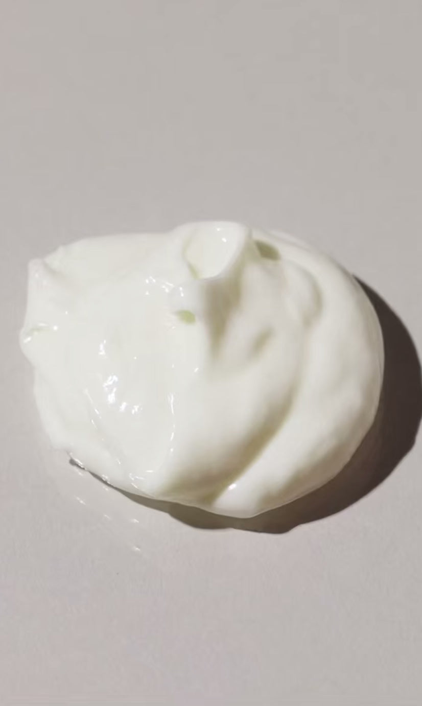 Close-up of creamy, thick, moisturizing leave-in conditioner for curly and coily hair textures, hydrating